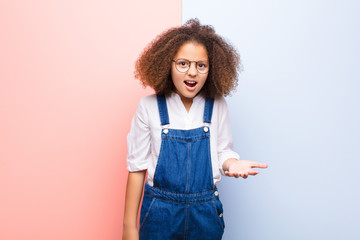 african american little girl looking angry, annoyed and frustrated screaming wtf or what‚Äôs...