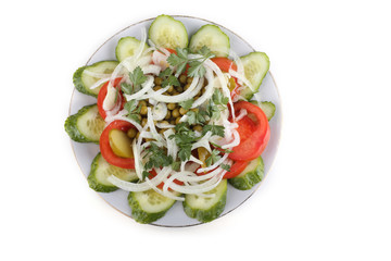 Cucumber and tomato slices, pea and onion on dish