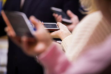 Abstract man in a suit and tie speaks to reporters