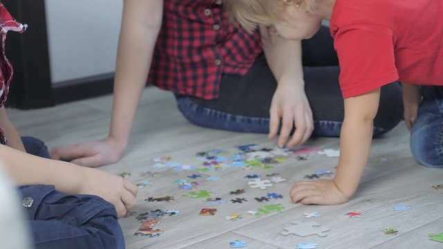little daughter girl happy family lifestyle collection puzzles teamwork. development of fine motor skills and thinking. daughter and girl with mom a collect mosaic puzzles