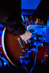 Guitarist bass on stage for background, colorful, soft focus and blur