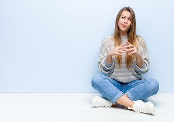 young blonde woman scheming and conspiring, thinking devious tricks and cheats, cunning and...