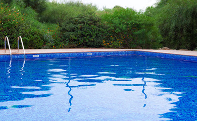 Outdoor swimming pool at summer time.