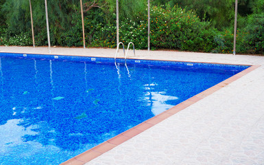 Outdoor swimming pool at summer time.