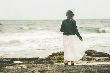 Back view of Pensive Young woman on the beach