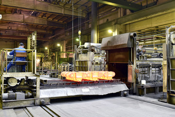 hardening of steel components in a foundry - red-hot components come out of the oven