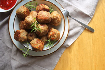 Roasted meatballs , delicious meat cutlets on wooden table . Top view