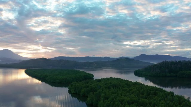 Aerial footage of Beautiful Rural village landscape with green forest in surrounding in Mengkabong River, Tuaran, Sabah, Borneo