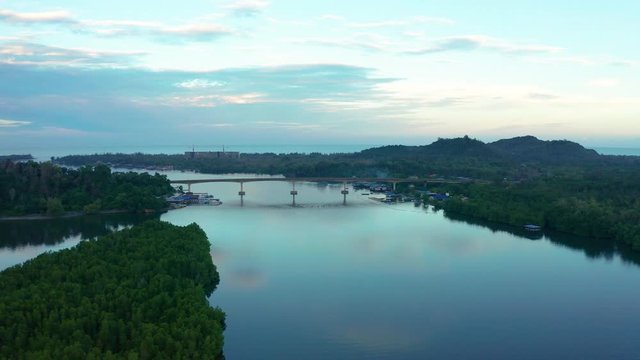 Aerial footage of Beautiful Rural village landscape with green forest in surrounding in Mengkabong River, Tuaran, Sabah, Borneo