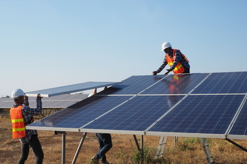 Engineers and workers are inspecting solar cells.
