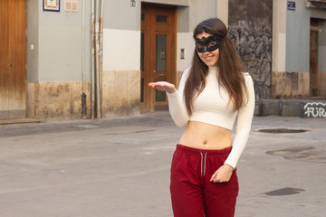pretty caucasian young woman with mask copyspace imaginary on palm to insert advertisment, in the...
