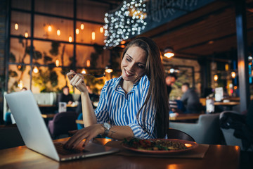 businesswoman freelance having busy lunch in restaurant