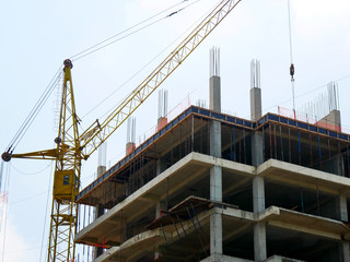Fototapeta na wymiar Concrete building under construction. Construction site. Tower cranes near building.