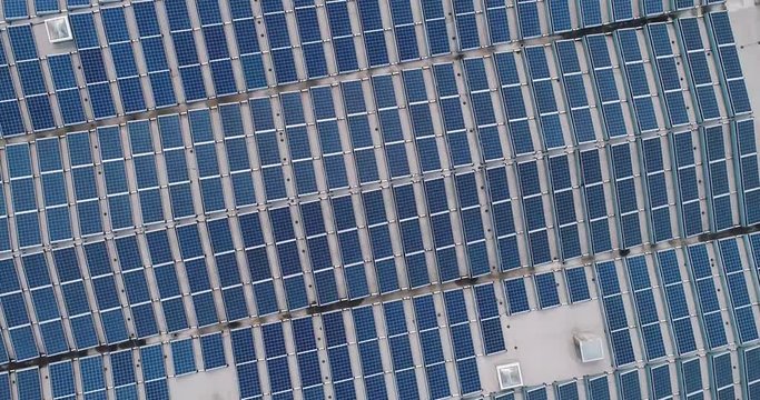 vertical circular panorama of solar panels on factory roof, slow