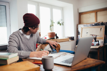 young man freelancer working from his home