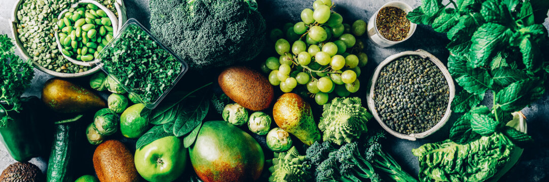Variety of Green Vegetables and Fruits on the grey background, banner size