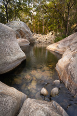 Rock pool in the Australian outback with sunset glow and a tranquil feel