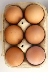 Pack of six free range eggs on white background. Top view.