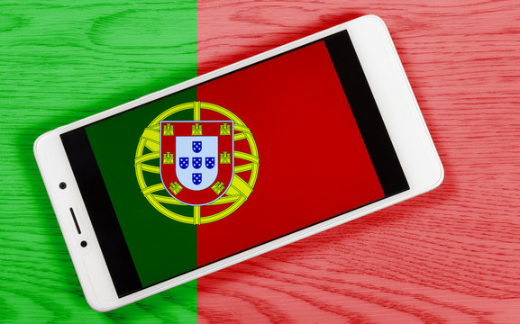 Creative Portuguese Flag Consisting of a Smartphone over a Wooden Background