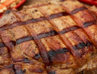 Obraz na płótnie Canvas texture of grilled on the grill a piece of pork meat on the rib
