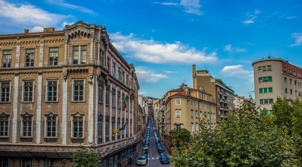 Fototapeta na wymiar rustic dirty Italian narrow street parking card alley and buildings sunny vivid clear weather summer day time panoramic picture in Trieste city