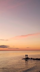 Naklejka na ściany i meble silhouette of fisherman at sunset