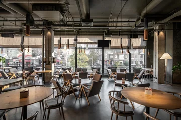 Foto op Plexiglas Interior of modern cafe in loft style © Andriy Bezuglov
