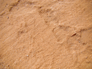 Background desert surface for background. The main color is Whiskey Sour. Deepenings, stones, elevations. Concept of the relief of the arid region, Mars.