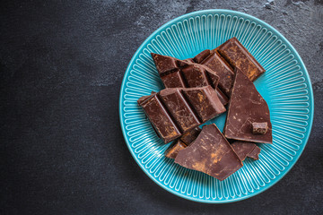 chocolate (delicious cocoa dessert, pieces sweets) menu concept. food background. top view. copy space 