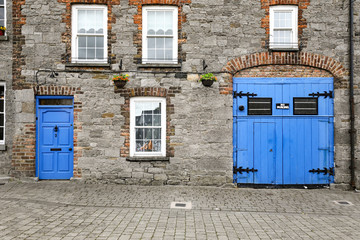 Fototapeta na wymiar Old stone building in Ireland with bright blue doors
