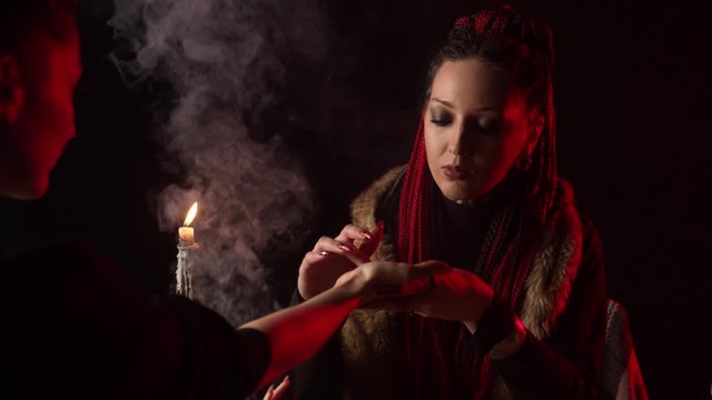 Palmist predicting future by hand to girl