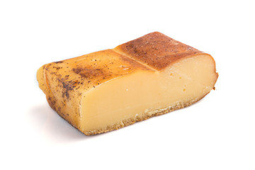 Piece of smoked cheese isolated on white background. Side view.