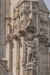 Fototapeta na wymiar Sculptures on Saint-Jacques Tower (Tour Saint-Jacques) located on Rivoli Street in Paris, France. 52 m Flamboyant Gothic tower - remains of former XVI century Church of Saint-Jacques-de-la-Boucherie.