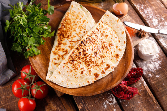 Azerbaijani national cuisine is distinguished by kutabs on a plate.
