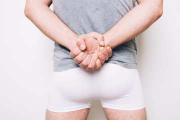 athletic male butt in white boxers. men's health problems: hemorrhoids, prostatitis. disease...