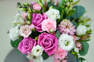 Fototapeta na wymiar Bouquet of bright fresh flowers in a pink pot