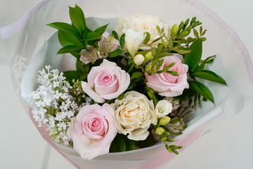 Bouquet of fresh roses on a light gray background natural background