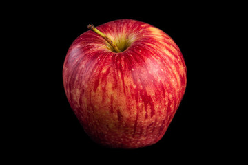 Fresh red apple placed on black background