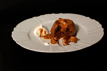 Inside chocolate cupcake ice cream and caramel isolate on black