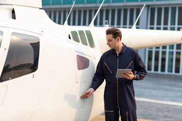 Engineer maintaining a helicopter Engine. Male engine machanic helicopter checking helicopter before take off © NVB Stocker