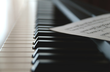 Keys of electronic piano, synthesizer, music instrument with sheet music  and notes    