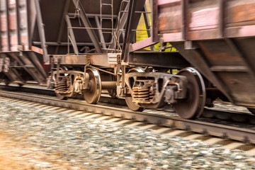wheelset of a railway car rushes along the rails with great speed blur.