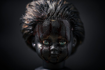 Creepy bloody doll in the dark