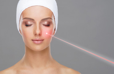 Doctor removing moles using laser ray. Beauty portrait of a young woman. Birthmark removal, plastic surgery, skin lifting and aesthetic medicine. - obrazy, fototapety, plakaty