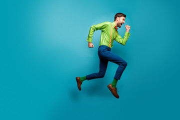 Fototapeta na wymiar Full length body size view of nice attractive crazy energetic purposeful cheerful guy jumping running fast active isolated on bright vivid shine vibrant blue green teal turquoise color background