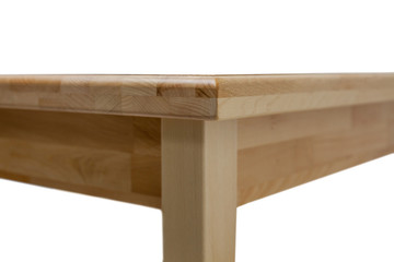 View of the corner of a wooden modern kitchen table. Kitchen dining table isolated on white background.