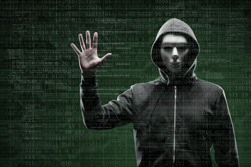 Anonymous computer hacker over abstract digital background. Obscured dark face in mask and hood. Data thief, internet attack, darknet fraud, dangerous viruses and cyber security.