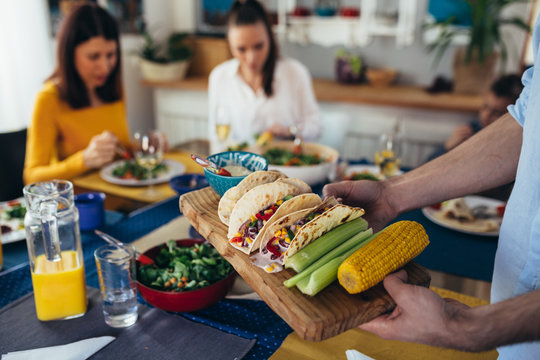 close up of vegetarian food. family sits at the dining table and having dinner party at home.