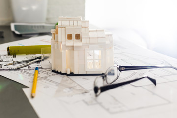 building house on blueprints with worker - construction project