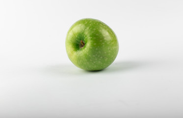 A single green fresh apple isolated on white background. front view